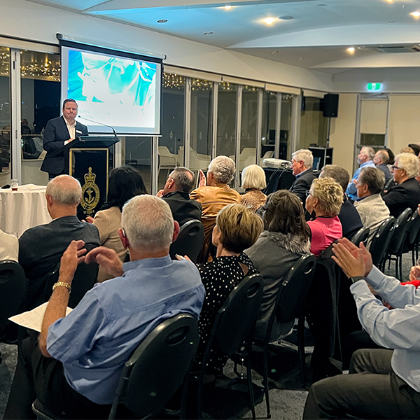 Cameron Glover presents to a large group of people.