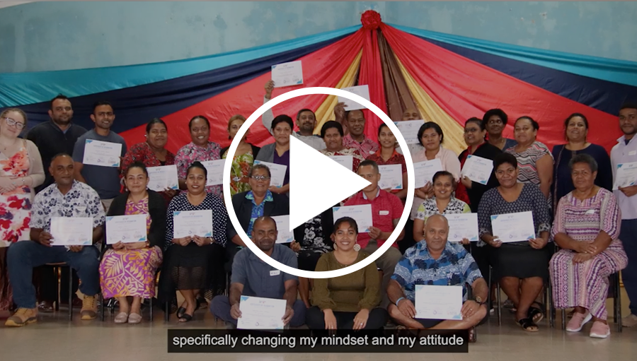 Video thumbnail showing a group of gender and race diverse people smiling and holding certificates.