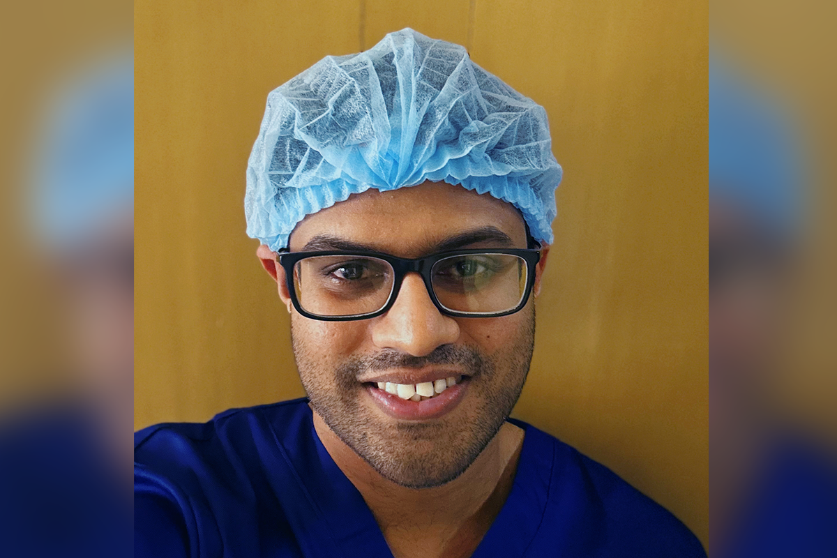 Photo of Dr Samarathunga in scrubs and hair net.