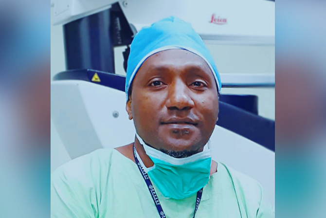 Photo of Dr Nuli in surgical scrubs.