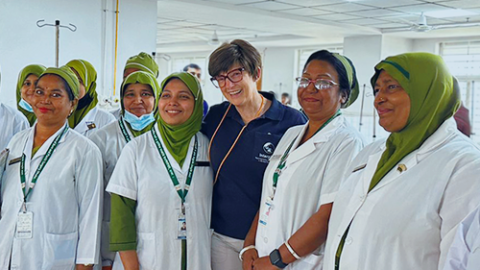 Jan Rice takes a photo with group of senior nursing staff in hospital ward.