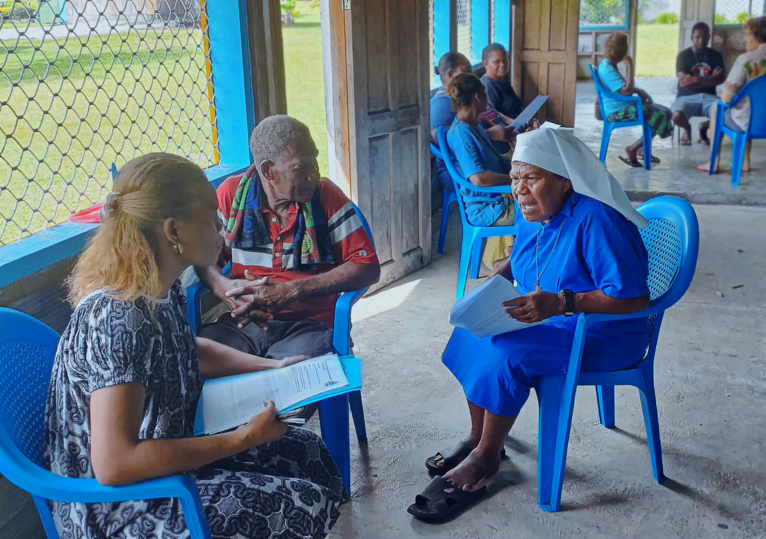 Small groups of people sit in circles to talk.